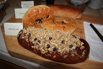 Bread with nuts and raisins on a wooden board.