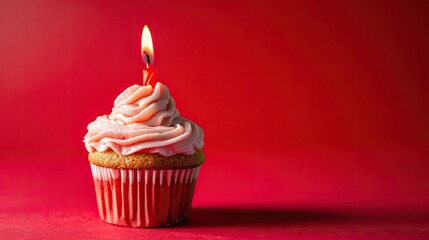 Red Birthday Cupcake with Pink Frosting and Lit Candle