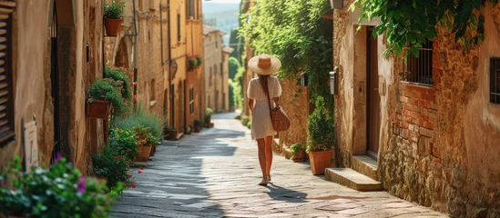 Cercles muraux Toscane Travel in Italy happy trendy woman with straw bag having excursion in Pienza in Tuscany Italy. Copy space image. Place for adding text