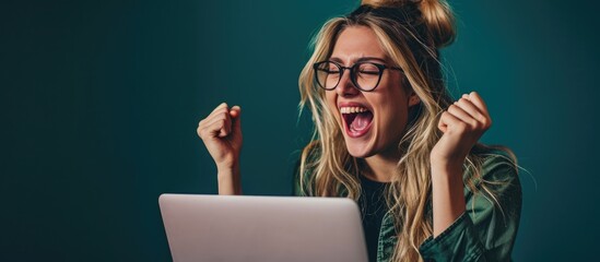 Joyful millennial woman with laptop excited with success looking at screen making win yes gesture Happy girl with computer getting good news offer learning about mortgage reward career promotio
