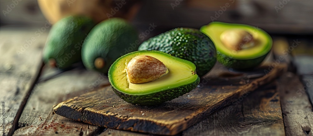 Poster ripe avocado on a wooden board in the studio. copy space image. place for adding text