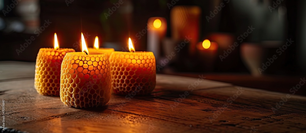 Poster a handmade of natural wax with texture of honeycomb bees candles burns on table an unusual element o