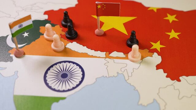 Chess pieces over a map of Idnia and China. India-China Border Dispute . Selective focus