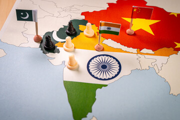 Chess pieces over a map of Idnia and China. indo-pakistani Border Dispute . Selective focus