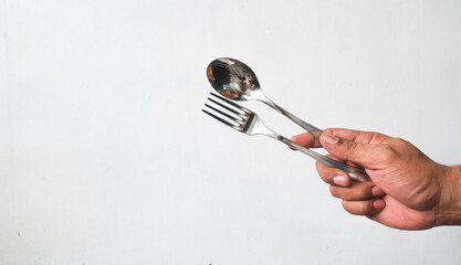 portrait of man's hand holding spoon and fork isolated on white background