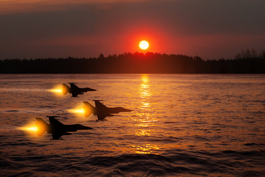Air Force Day. Aircraft silhouettes on background of sunset on the sea.