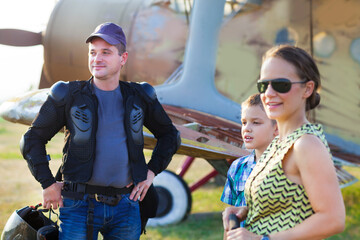 Family with little son near the vintage airplane