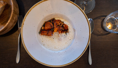 Dark roasted butter pumpkin with whipped creamy sauce make with Ossau-Iraty sheep cheese from Basque County France served in French restaurant in Bordeaux region