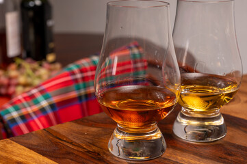 Tasting of different Scotch whiskies strong alcoholic drinks, drum of whiskey and colorful Scotch...