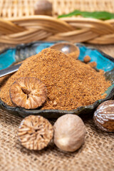 Tasty winter spice whole dried and ground powder nutmeg, used as an ingredient in many dishes, eggnog, potato, mulled wine
