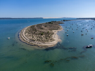 Aerial view on Arcachon Bay with many fisherman's boats and oysters farms near Le Phare du Cap...
