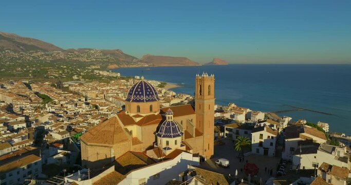 Aerial view of the city of Altea and the picturesque Mediterranean coast. Spain. An ancient Catholic church on the mountain as a landmark of the city of Altea