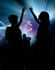People, dancing and crowd or concert silhouette for live music performance or festival, rock or...