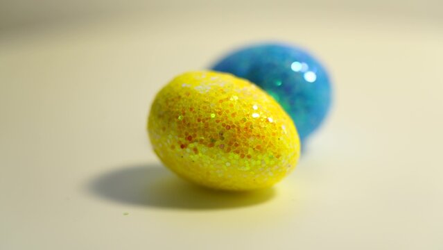 Colorful Easter eggs rotating in rows in a seamless loop on a light background - Powered by Adobe