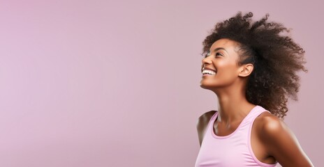 Side view of young african american sports fitness woman in sportswear working out isolated on pink background studio portrait. Sport exercises healthy lifestyle concept