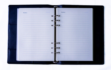 Notebook with lines, black leather cover, white background, isolated