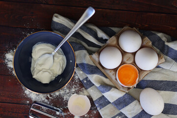  concept cooking four eggs one of them is broken flat lay