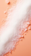 scattered diagonally sugar or salt on a peach background, top view. concept sugar, health, crystals, salt, pressure