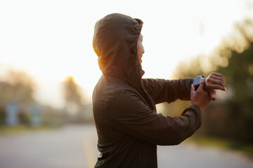 Portrait of a young Asian man in sports clothes jogging in the morning. man running at sunrise...