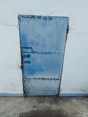 Rusty blue iron door commonly used in old textile factories