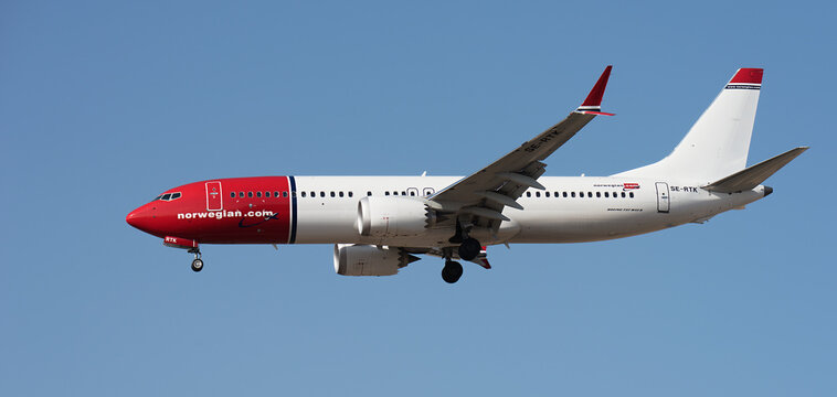 Tenerife, Spain January 16 st, 2024. Boeing 737 MAX 8 Norwegian Airlines flies in the blue sky. Landing at Tenerife Airport