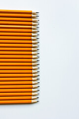 Yellow simple pencils lie on a white background.
