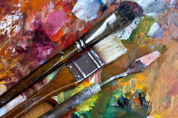 Old brushes and palette with paints