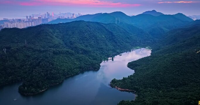 Aerial photography of Shenzhen reservoir with mountains and city skyline
