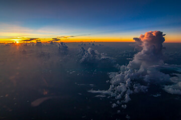 Aerial view of majestic sunset behind high cumulus clouds