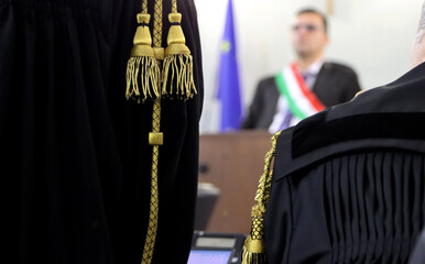 A lawyer's speech during a trial in an Italian court, with the judge blurred in the background