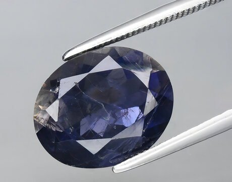 natural blue iolite kordierite gem on the background