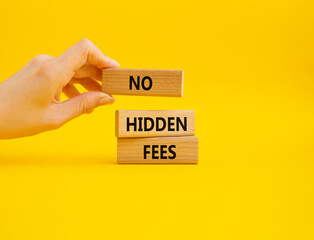 No hidden fees symbol. Concept word No hidden fees on wooden blocks. Businessman hand. Beautiful yellow background. Business and No hidden fees concept. Copy space - obrazy, fototapety, plakaty