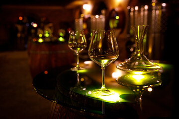 Wine glasses and decanter in a vintage cellar.