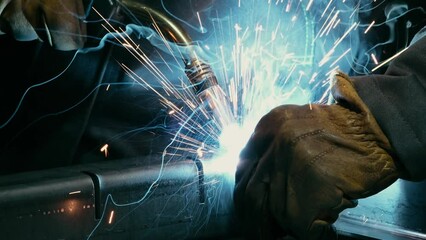 Close-up of a blacksmith welder working with metal using a welding machine, bright sparks and flashes in slow motion - Powered by Adobe
