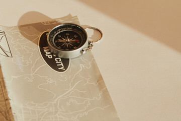 A compass lies on a map with the inscription ‘map to the city