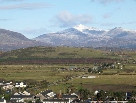 A long range winter view over Harlech, Gwynedd, Wales, towards Mount Snowdon and the mountains in the  Snowdonia National Park.