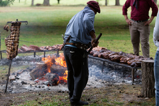 guacho roasting angus beef in the pampas countryside