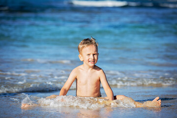 Young boy playing on the seashore