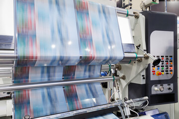 new innovative technology of automatic label printing machine with digital control panel. printing on continuous plastic film for wrapping on food product packaging in the printing factory. - obrazy, fototapety, plakaty