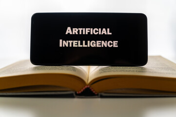 Book and device with text Artificial Intelligence. Learning, use, tools and data processing of artificial intelligence,