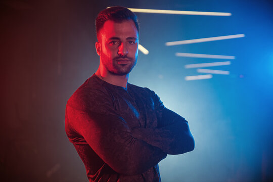Confident Athlete in Gym with Dramatic Lighting