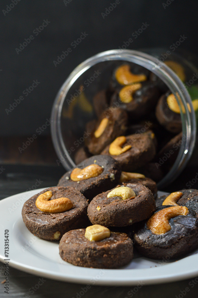 Poster Homemade chocolate cake with cashew nut topping.