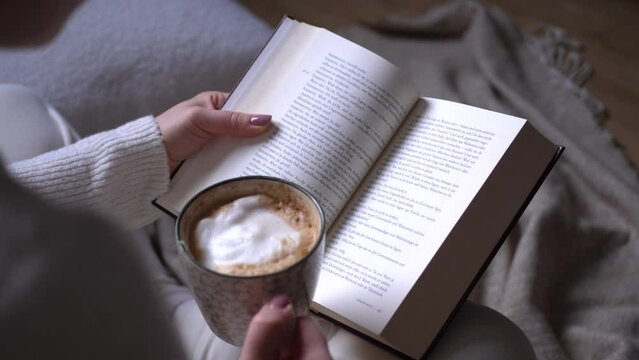 Female Person Reading A Book And Drinking Coffee