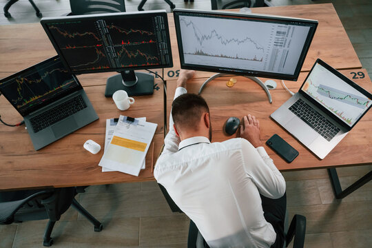 Tired, sleeping on the table. Businessman is sitting by computer and working in the office