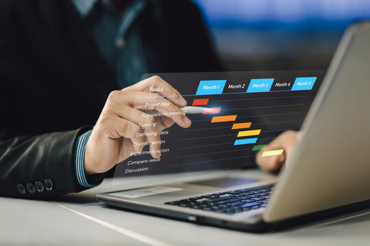 Project manager working and update tasks with milestones progress planning. Businessman using laptop computer plan schedule virtual diagram, business project management concept.