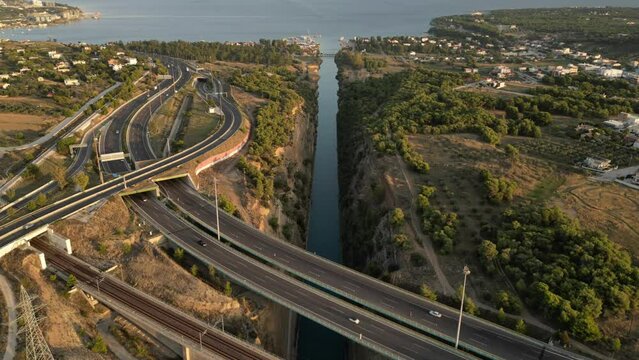 drone hyperlapse of the Corinth Canal, capturing cars driving over the bridges.
