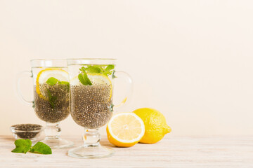 Healthy breakfast or morning with chia seeds lemon and mint on table background, vegetarian food,...