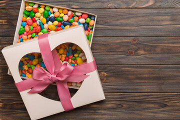 Box with sweet chocolate candies on color background, Various candy sweets. Valentines day gift...