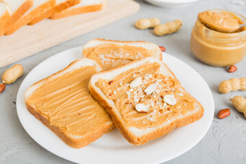 Peanut butter sandwiches or toasts on light table background.Breakfast. Vegetarian food. American cuisine top view vith copy space