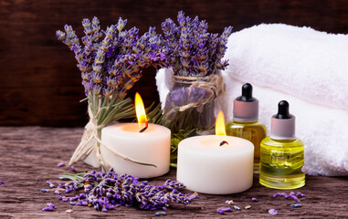 Obraz na płótnie Canvas relaxing spa set of sea salt, aromatic oils, candles and lavender